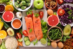 Food representing a healthy diet - salmon, nuts, seeds and fruits and vegetables