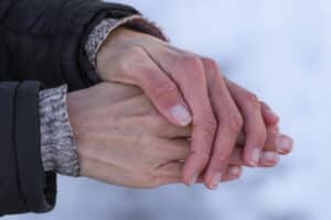 Frozen women's hands.The girl is trying to warm her frozen in the cold hands.Care for the skin of the hands in the winter.