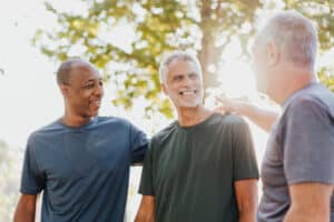 Three male friends having fun in the public park