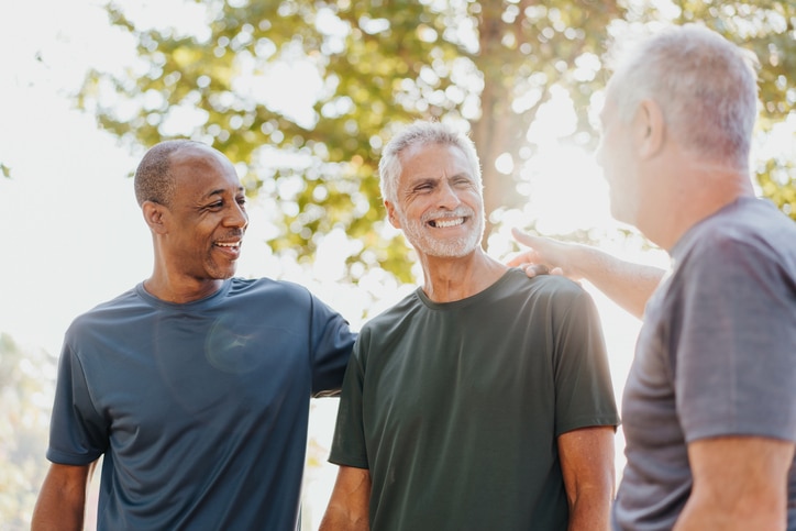 Three male friends having fun in the public park